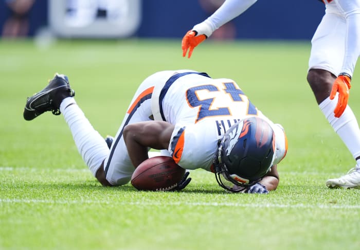 Denver Broncos safety Keidron Smith (43) recovers fumble in the second quarter against the Arizona Cardinals at Empower Field at Mile High.
