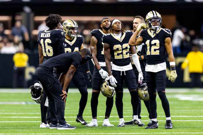 New Orleans Saints wide receiver Rashid Shaheed (22) and wide receiver Chris Olave (12) and wide receiver Bub Means (16) look at the video boards on a time out against the Carolina Panthers