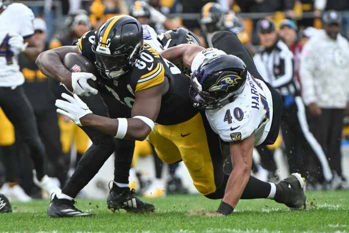 Pittsburgh Steelers tight end Darnell Washington (80) dives for extra yardage while being tackled by Baltimore Ravens linebacker Malik Harrison (40).