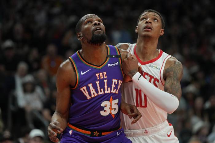 Phoenix Suns forward Kevin Durant and Houston Rockets forward Jabari Smith Jr. fight for rebounding position at Footprint Center on March 30, 2025.