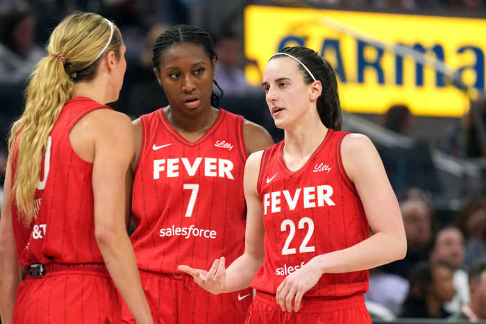 Indiana Fever guard Caitlin Clark talks to guard Lexie Hull and forward Aliyah Boston
