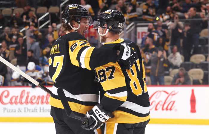 Pittsburgh Penguins right wing Rickard Rakell (67) and center Sidney Crosby (87) celebrate a goal by Rakell against the St. Louis Blues during the third period at PPG Paints Arena.