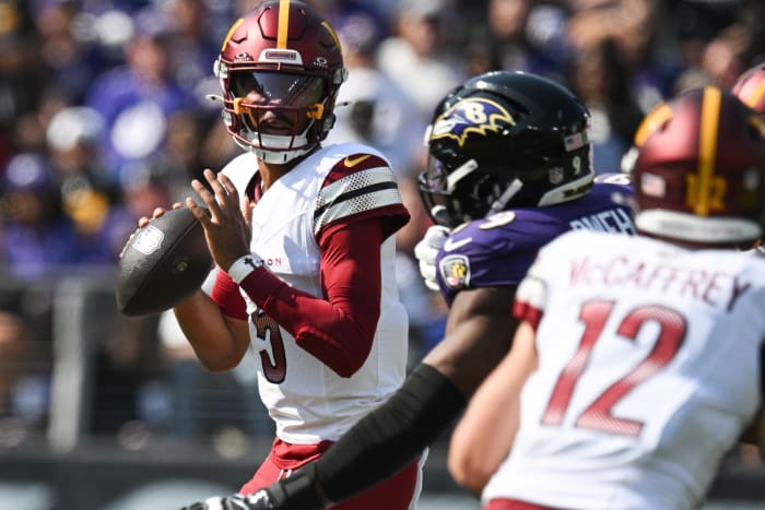 Oct 13, 2024; Baltimore, Maryland, USA; Washington Commanders quarterback Jayden Daniels (5) loos to throws during the first quarter against the Baltimore Ravens at M&T Bank Stadium.