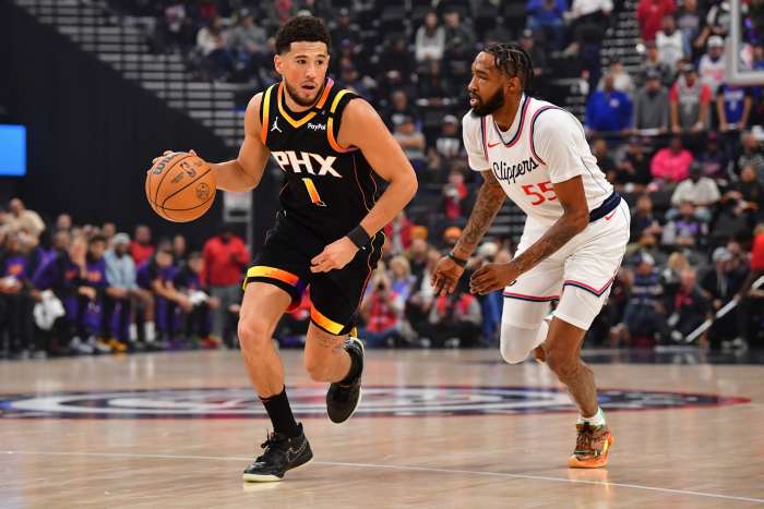 Phoenix Suns guard Devin Booker pushes the ball upcourt as Los Angeles Clippers forward Derrick Jones Jr. defends at Intuit Dome on Oct. 31, 2024.