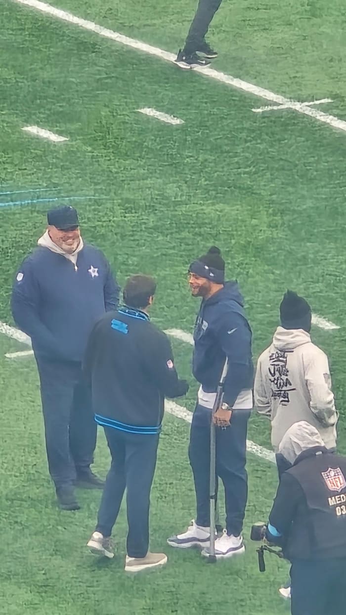 Dak Prescott on field with crutches
