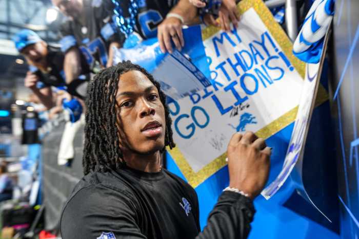 Detroit Lions running back Jahmyr Gibbs (26) signs autographs during the pregame for the N.F.L. game between the Detroit Lions and the Seattle Seahawks at Ford Field in Detroit, Monday, Sept. 30, 2024