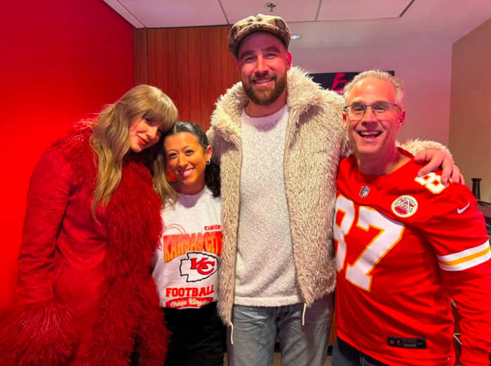 Chiefs tight end Travis Kelce and Taylor Swift poses with fans at Arrowhead Stadium on Dec. 21, 2204.