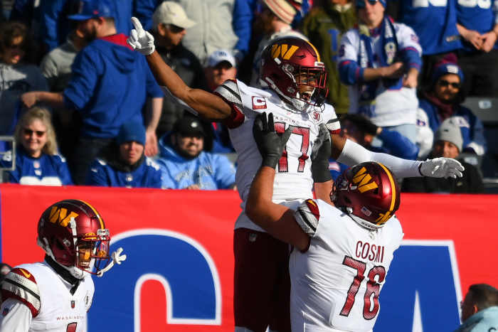 Washington Commanders WR Terry McLaurin (17) celebrates a touchdown catch with offensive tackle Sam Cosmi (76).