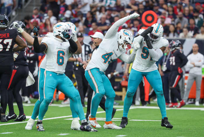Dec 15, 2024; Houston, Texas, USA; Miami Dolphins linebacker Chop Robinson (44) celebrates with teammates after a defensive play during the third quarter against the Houston Texans at NRG Stadium.
