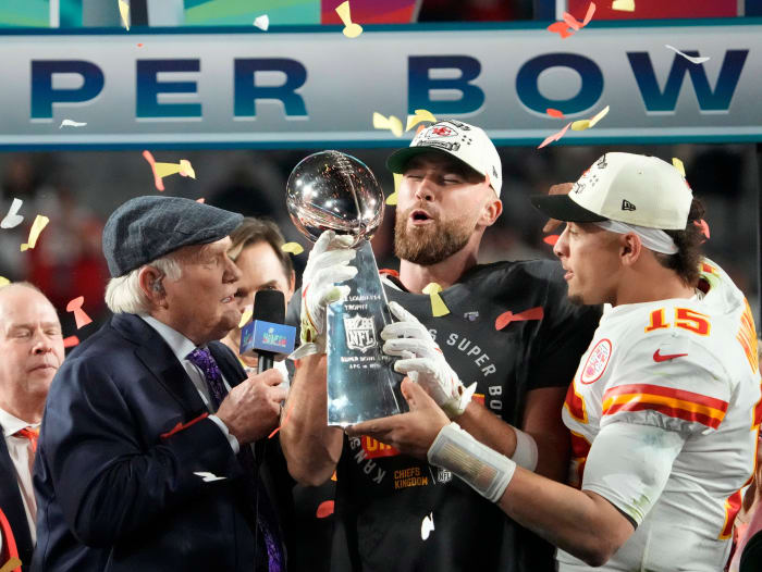 Kansas City Chiefs quarterback Patrick Mahomes passes Lombardi Trophy to Travis Kelce.