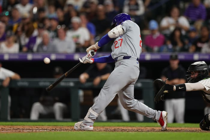 Chicago Cubs designated hitter Seiya Suzuki hits a single in the fifth inning against the Colorado Rockies.