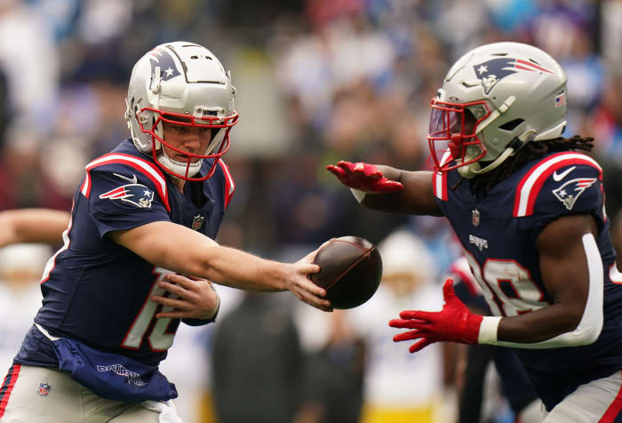 New England Patriots quarterback Drake Maye (10) hands off the ball to running back Rhamondre Stevenson (38).