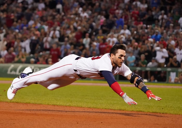Jul 28, 2021; Boston, Massachusetts, USA; Boston Red Sox second baseman Michael Chavis (23) dives into third base for a triple against the Toronto Blue Jays in the sixth inning during game two of a double header at Fenway Park.
