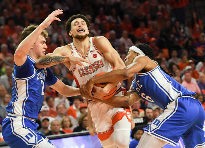 Clemson Tigers guard Chase Hunter (1) is fouled by Duke blue Devils forward Maliq Brown (6) near Duke forward Cooper Flagg (2), left, during the first half at Littlejohn Coliseum.