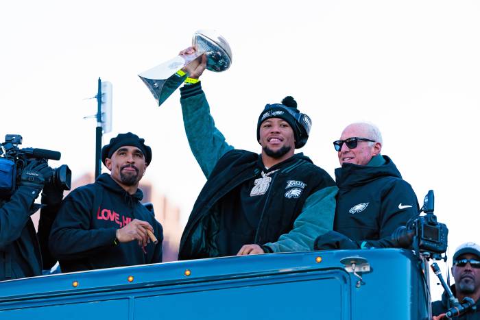 Philadelphia Eagles running back Saquon Barkley (26) lifts the Lombardi Trophy during the Super Bowl LIX championship parade.