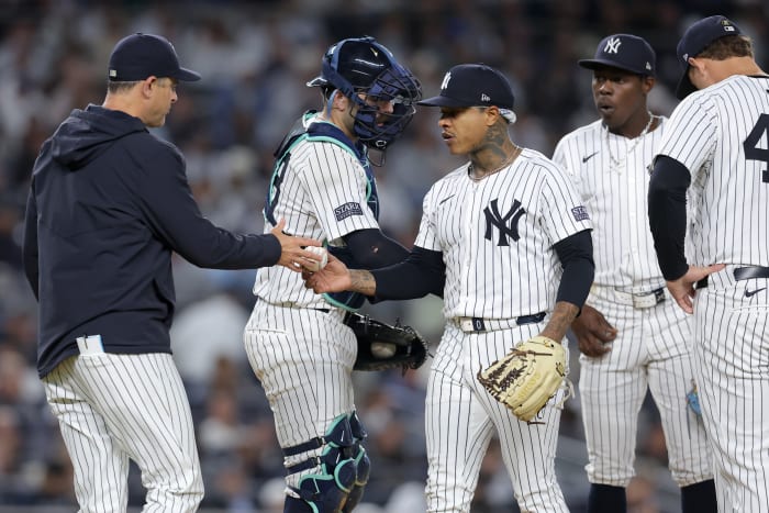 Sep 25, 2024; Bronx, New York, USA; New York Yankees manager Aaron Boone (17) takes the ball from starting pitcher Marcus Stroman (0) during the fourth inning against the Baltimore Orioles at Yankee Stadium.