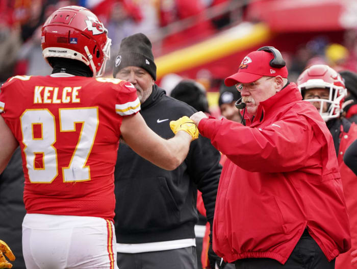 Kansas City Chiefs head coach Andy Reid fist-bumps TE Travis Kelce after scoring a touchdown against the Seattle Seahawks.