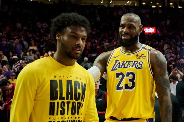 Los Angeles Lakers forward LeBron James (23) celebrates victory over the Portland Trail Blazers with his son Bronny James (9).