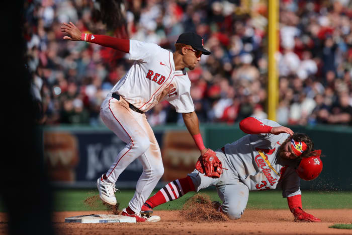 St. Louis Cardinals second baseman Brendan Donovan (33) slides past Boston Red Sox second baseman Kristian Campbell (28) during the ninth inning at Fenway Park.