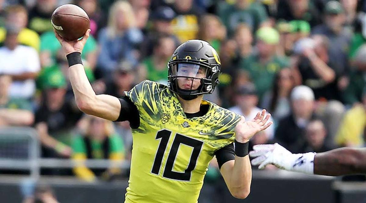 Justin Herbert Oregon Ducks Unsigned Yellow Jersey Running with Ball vs.  Arizona State Photograph