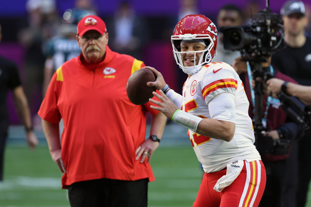 Feb 12, 2023; Glendale, Arizona, US; Kansas City Chiefs head coach Andy Reid watches quarterback Patrick Mahomes (15) warm up before Super Bowl LVII against the Philadelphia Eagles at State Farm Stadium.