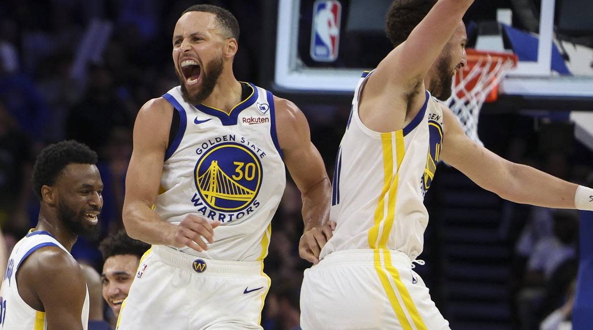 Warriors guards Stephen Curry and Klay Thompson jump in celebration after defeating the Magic.