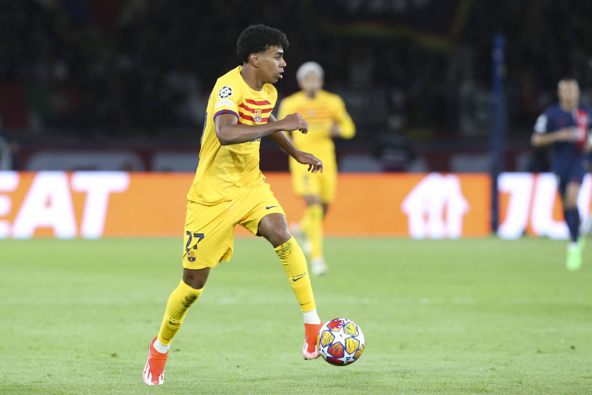 Lamine Yamal pictured dribbling with the ball during Barcelona's 3-2 win at Paris Saint-Germain in April 2024