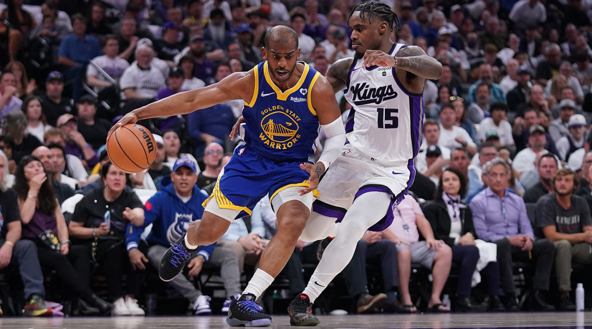 Golden State Warriors guard Chris Paul drives against Sacramento Kings guard Davion Mitchell on April 16, 2024.