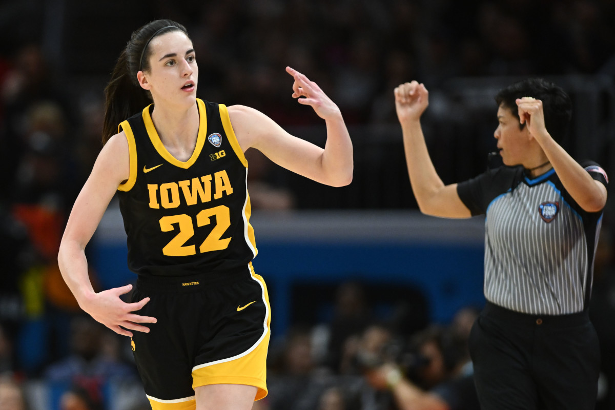 Caitlin Clark (22) reacts after making a three point basket in the finals of the Final Four of the women's 2024 NCAA Tournament at Rocket Mortgage FieldHouse.