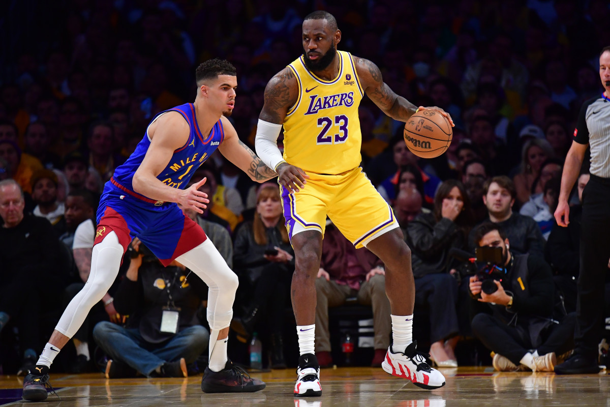 Apr 25, 2024; Los Angeles, California, USA; Los Angeles Lakers forward LeBron James (23) controls the ball against Denver Nuggets forward Michael Porter Jr. (1) during the first half in game three of the first round for the 2024 NBA playoffs at Crypto.com Arena.