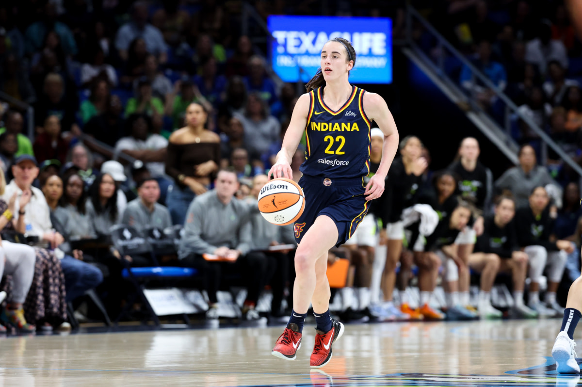 Indiana Fever guard Caitlin Clark (22) controls the ball during the first quarter against the Dallas Wings at College Park Center. 