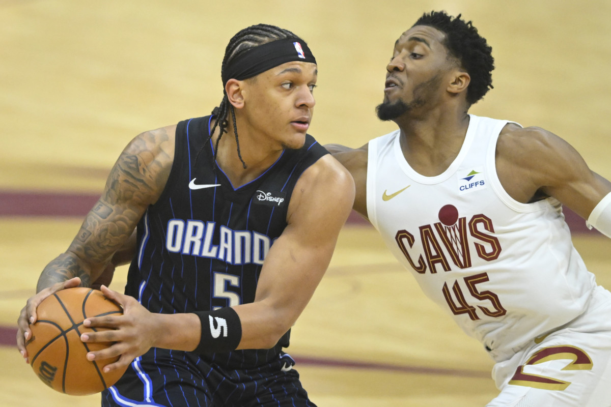 Apr 22, 2024; Cleveland, Ohio, USA; Orlando Magic forward Paolo Banchero (5) looks to pass beside Cleveland Cavaliers guard Donovan Mitchell (45) in the first quarter during game two of the first round of the 2024 NBA playoffs at Rocket Mortgage FieldHouse.