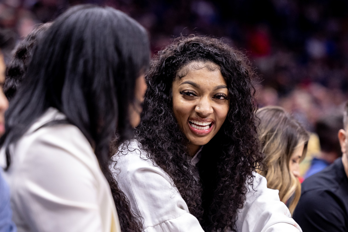 Apr 3, 2024; New Orleans, Louisiana, USA; LSU forward Angel Reese and forward Amani Bartlett watch the game between the New Orleans Pelicans and the Orlando Magic during the first half at Smoothie King Center.