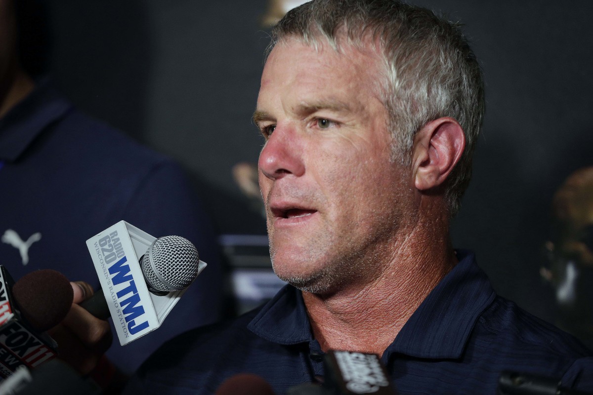 Former Green Bay Packers quarterback Brett Favre talks with the media at a press conference.