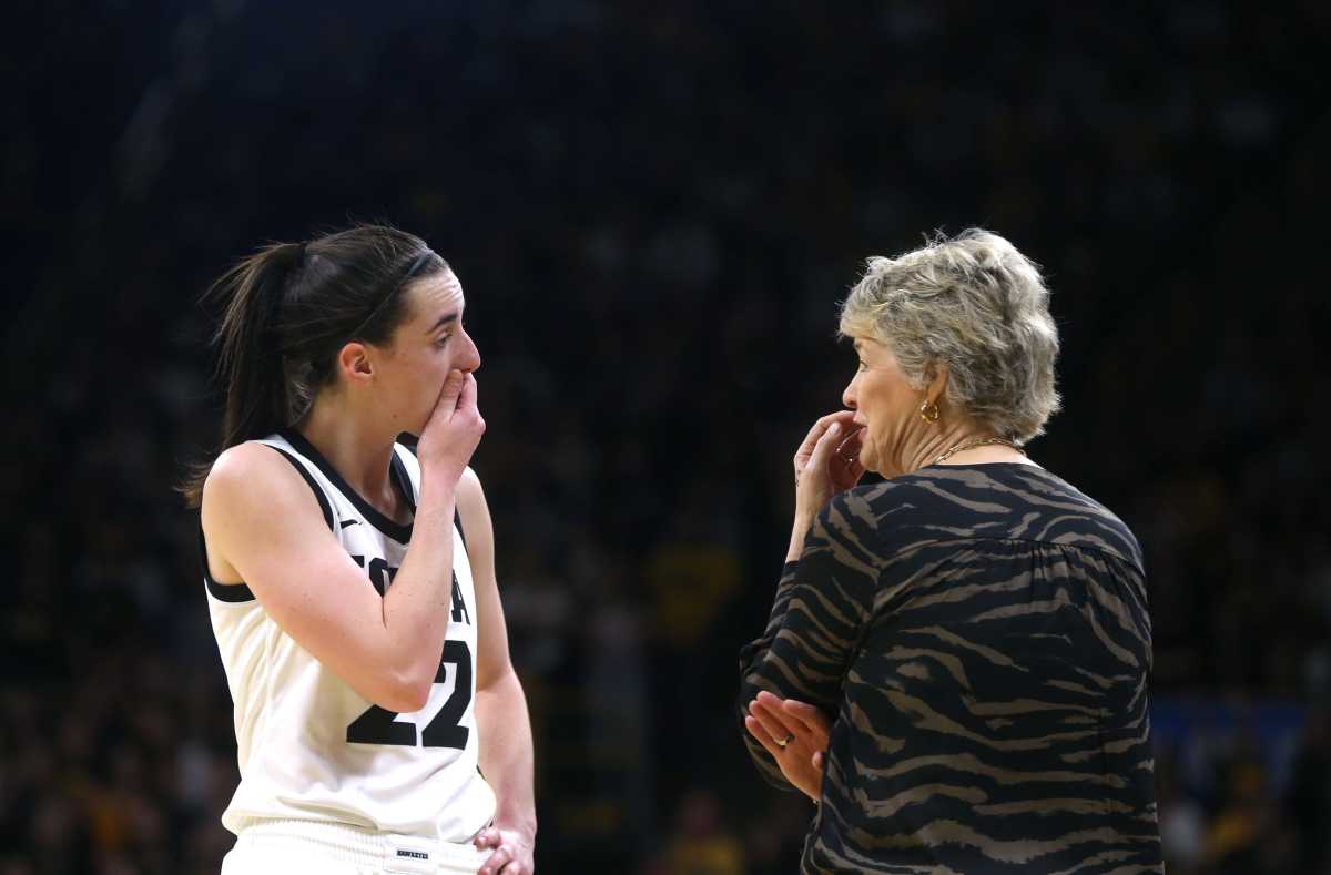 Iowa’s Caitlin Clark (22) talks to coach Lisa Bluder while playing Holy Cross in a first-round NCAA Tournament game Saturday, March 23, 2024 at Carver-Hawkeye Arena in Iowa City, Iowa.