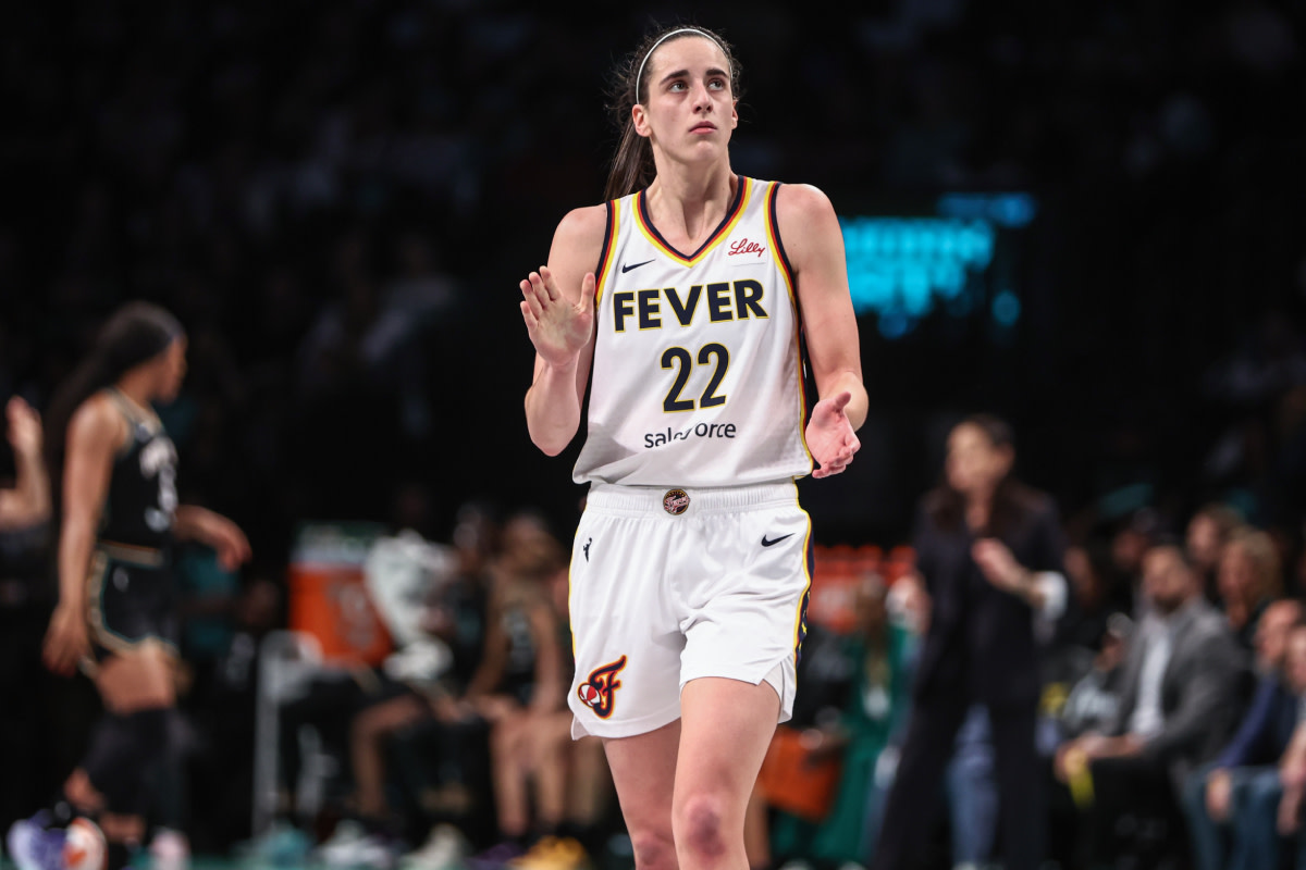 Indiana Fever guard Caitlin Clark (22) applauds while looking at the scoreboard in the third quarter against the New York Liberty at Barclays Center. 