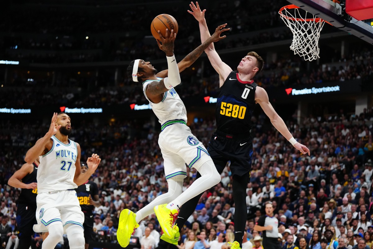 May 19, 2024; Denver, Colorado, USA; Minnesota Timberwolves forward Jaden McDaniels (3) shoots at Denver Nuggets guard Christian Braun (0) in the first half in game seven of the second round for the 2024 NBA playoffs at Ball Arena.