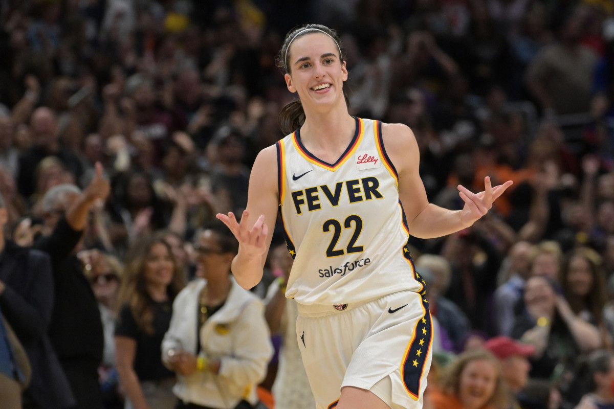 May 24, 2024; Los Angeles, California, USA; Indiana Fever guard Caitlin Clark (22) smiles as she heads down court after a 3-point basket in the final seconds of the game against the Los Angeles Sparks at Crypto.com Arena.