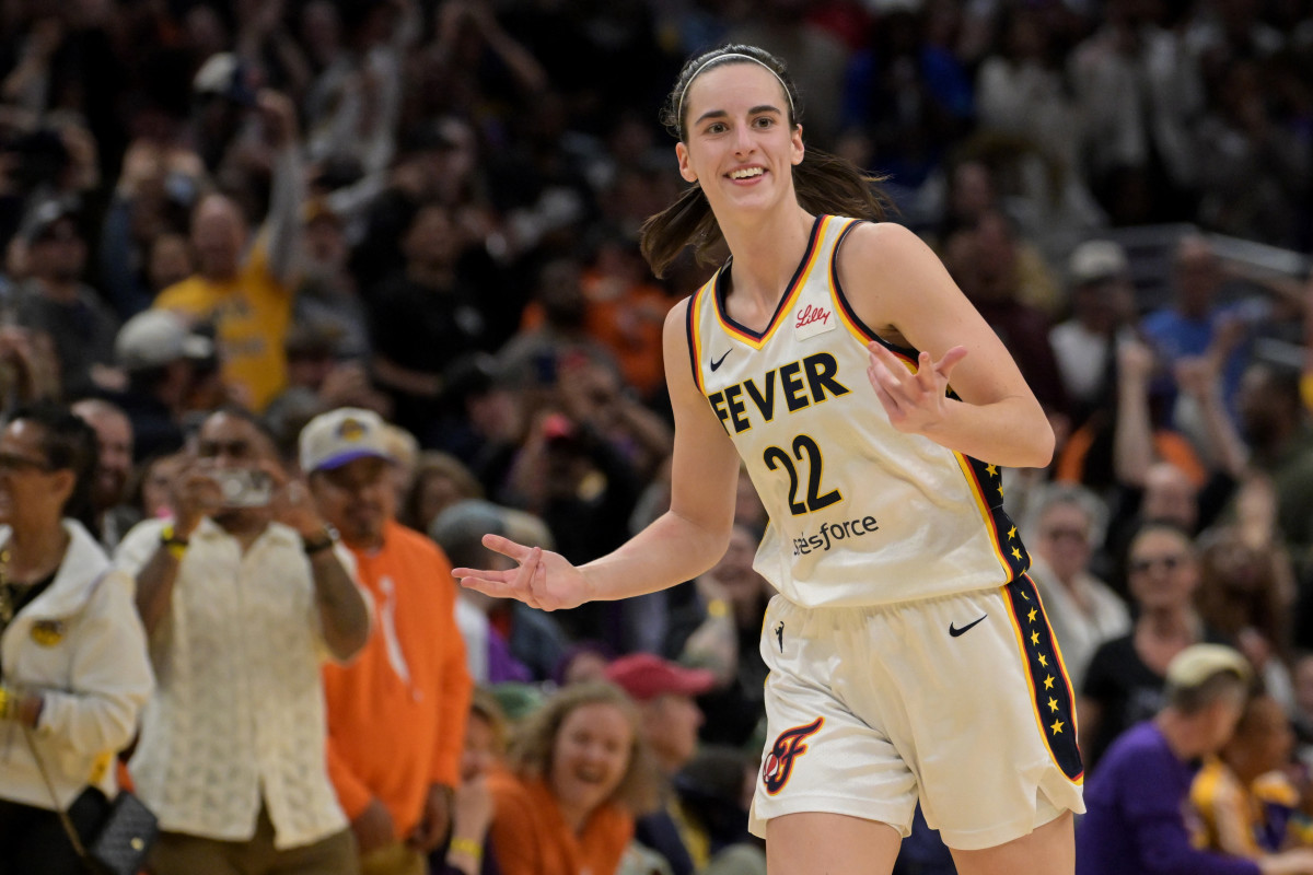 May 24, 2024; Los Angeles, California, USA; Indiana Fever guard Caitlin Clark (22) smiles as she heads down court after a 3-point basket in the final seconds of the game against the Los Angeles Sparks at Crypto.com Arena.