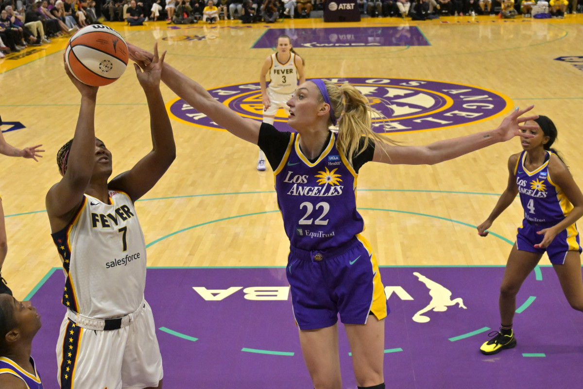 May 24, 2024; Los Angeles, California, USA; Los Angeles Sparks forward Cameron Brink (22) blocks a shot by Indiana Fever forward Aliyah Boston (7) in the first half at Crypto.com Arena.