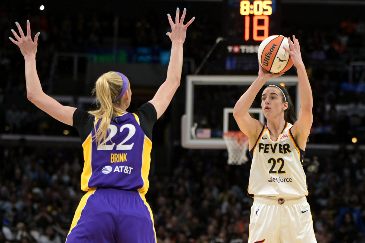 Indiana Fever guard Caitlin Clark (22) is defended by Los Angeles Sparks forward Cameron Brink (22) in the first half at Crypto.com Arena.