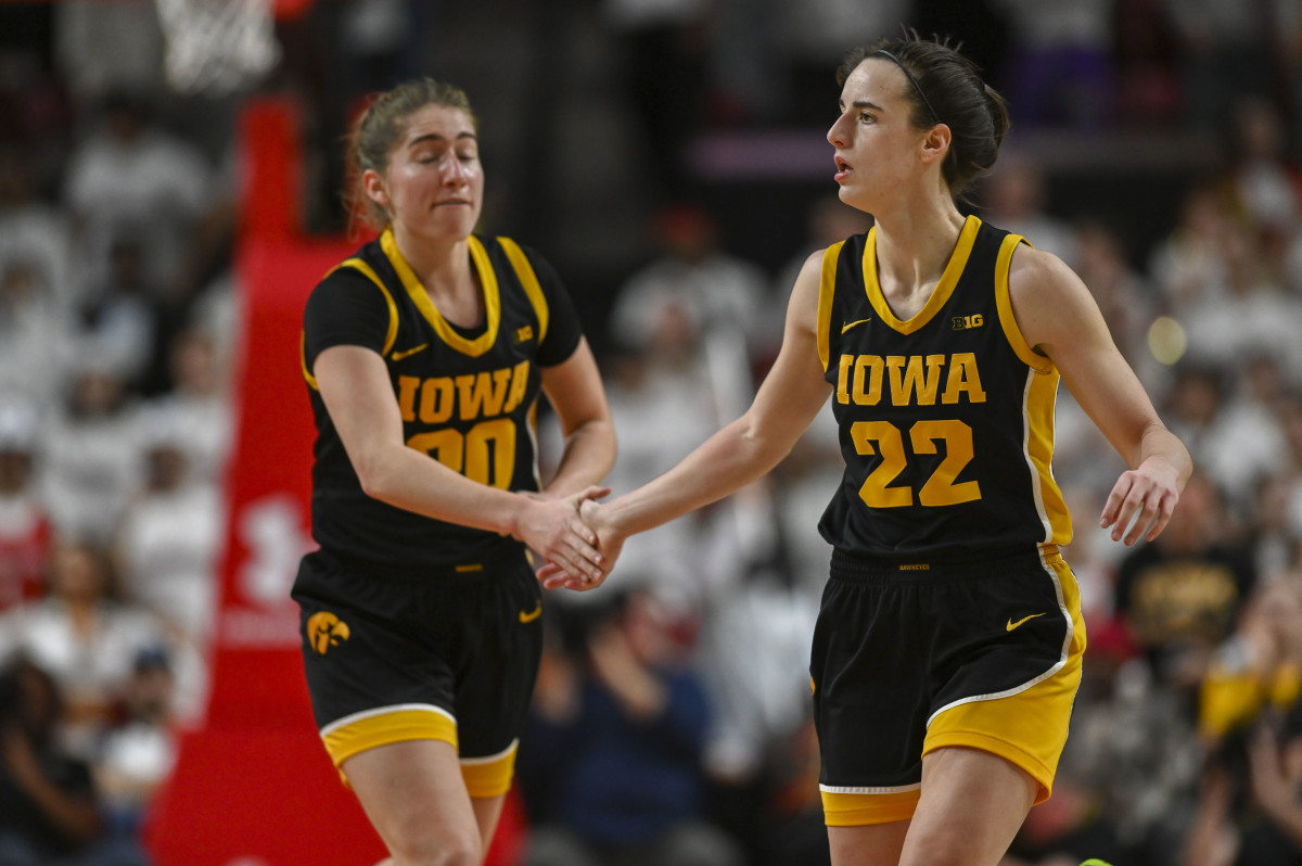 Feb 3, 2024; College Park, Maryland, USA; Iowa Hawkeyes guard Caitlin Clark (22) celebrates with guard Kate Martin (20) during the second half against the Maryland Terrapins at Xfinity Center.