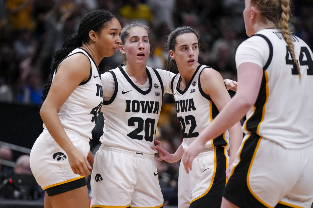 Apr 2, 2023; Dallas, TX, USA; Iowa Hawkeyes forward Hannah Stuelke, left, guard Kate Martin, middle, and guard Caitlin Clark huddle during a stop in play against the LSU Lady Tigers in the first half during the final round of the Women's Final Four NCAA tournament at the American Airlines Center.