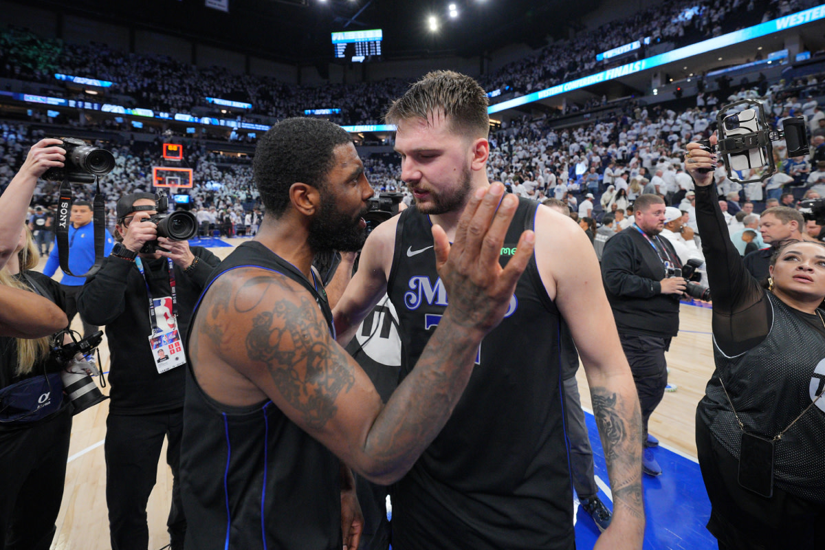 Dallas Mavericks guard Kyrie Irving (11) and guard Luka Doncic (77) celebrate after defeating the Minnesota Timberwolves in game two of the western conference finals for the 2024 NBA playoffs at Target Center.