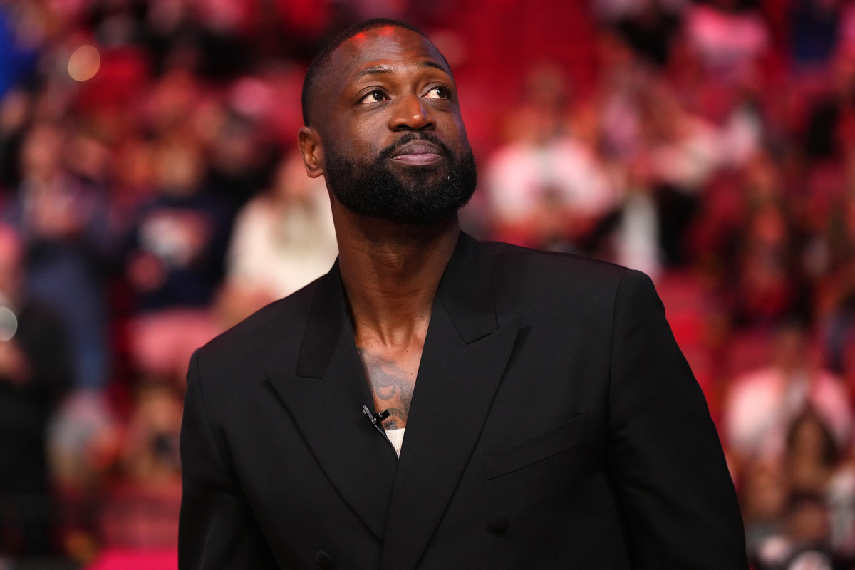 Jan 14, 2024; Miami, Florida, USA; Former Miami Heat player Dwayne Wade reacts after learning a statue will be erected outside of Kaseya Center in 2025, during a special ceremony during halftime of the game between the Miami Heat and the Charlotte Hornets.