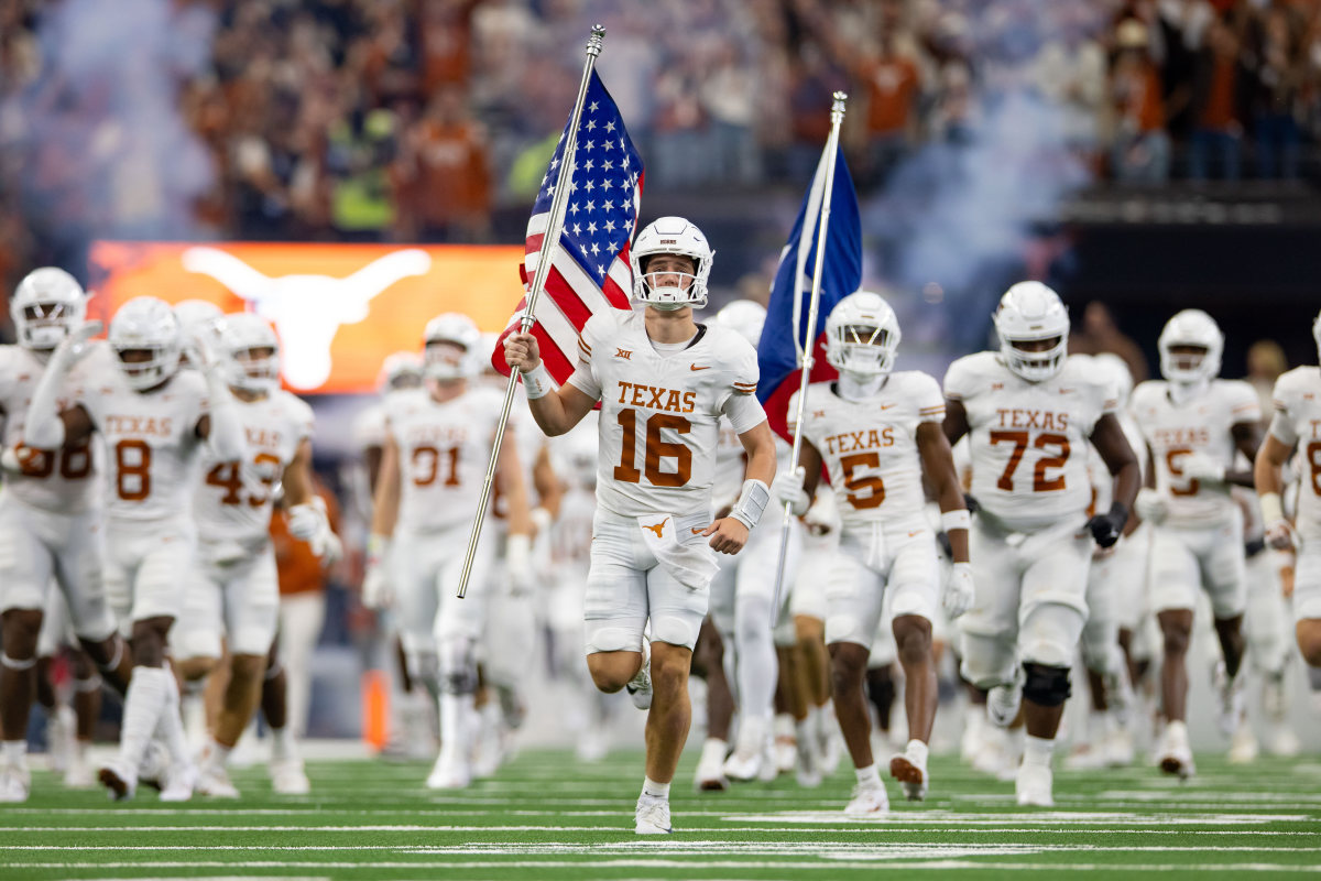 Dec 2, 2023; Arlington, TX, USA; Texas Longhorns quarterback Arch Manning (16) carries out the American flag prior to a game against the Oklahoma State Cowboys at AT&T Stadium. Mandatory Credit: Andrew Dieb-USA TODAY Sports