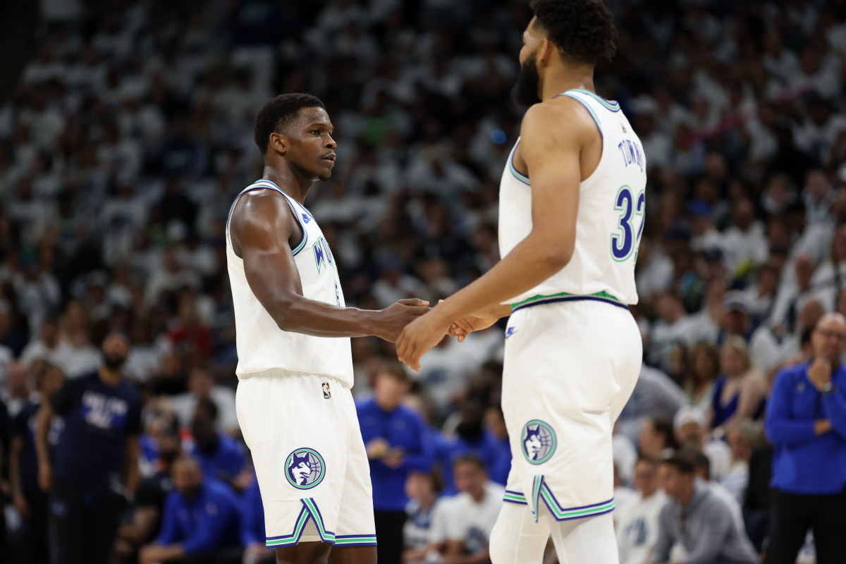 May 24, 2024; Minneapolis, Minnesota, USA; Minnesota Timberwolves guard Anthony Edwards (5) and center Karl-Anthony Towns (32) react in the first quarter against the Dallas Mavericks during game two of the western conference finals for the 2024 NBA playoffs at Target Center. Mandatory Credit: Jesse Johnson-USA TODAY Sports  