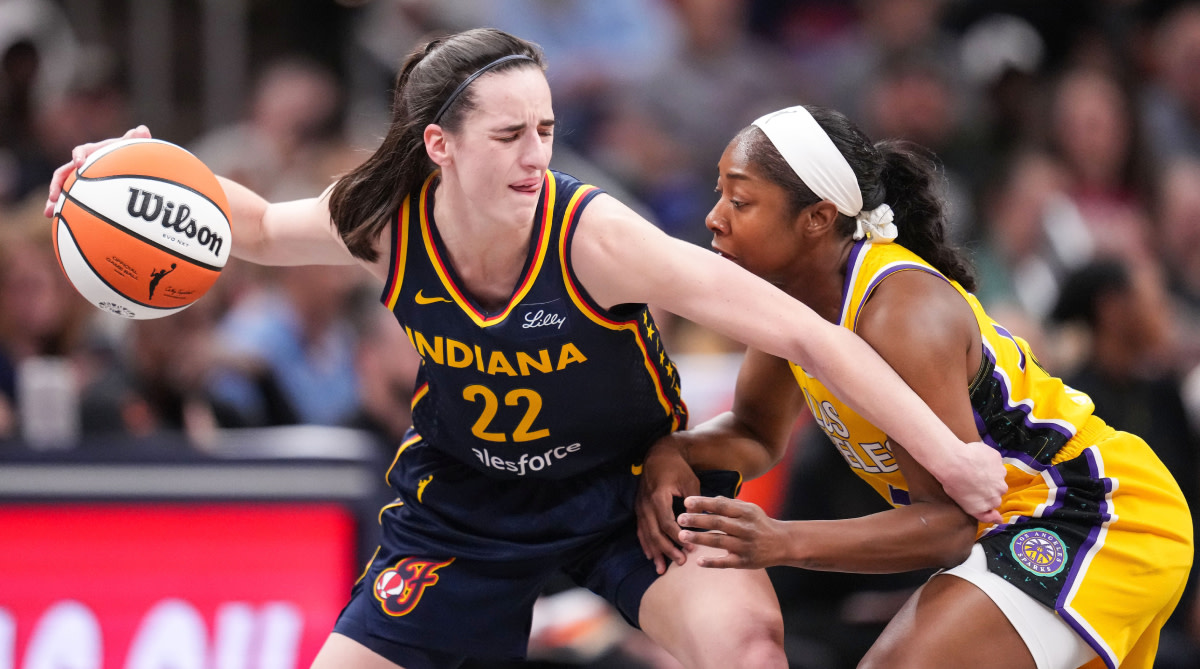 Indiana Fever guard Caitlin Clark (22) rushes up the court Tuesday,  May  28, 2024, during the game at Gainbridge Fieldhouse in Indianapolis. The Los Angeles Sparks defeated the Indiana Fever, 88-82.  