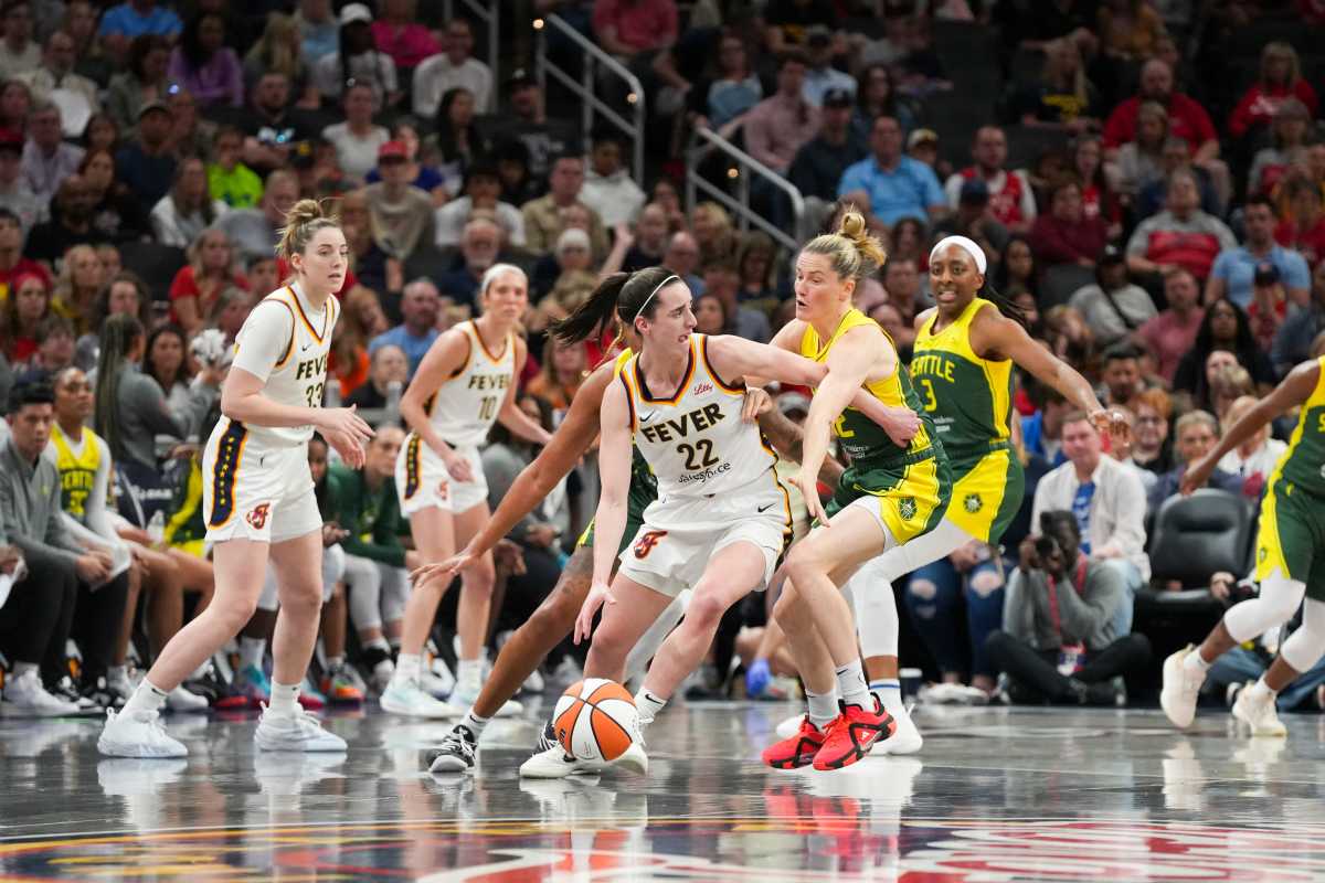 ndiana Fever guard Caitlin Clark (22) looks for an open teammate while being double-teamed by Seattle Storm players, Thursday, May 30, 2024, during the WNBA game at Gainbridge  Fieldhouse in Indianapolis.