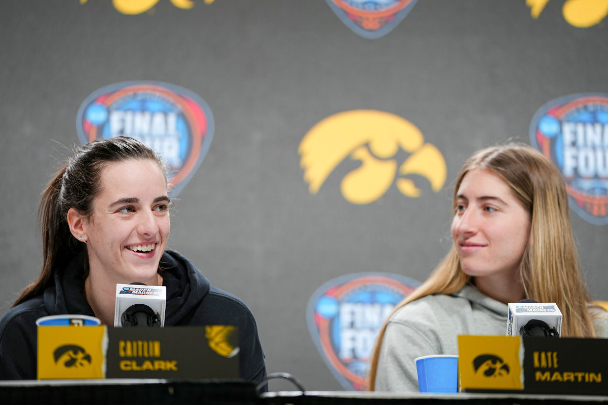 Iowa Hawkeyes guard Caitlin Clark (22) and guard Kate Martin (20) take questions at Rocket Mortgage Arena, Thursday, April 4, 2024 in Cleveland.